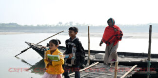 নতুন বই নিয়ে নদী পাড় হয়ে স্কুল থেকে ফিরছে শিশু সুমাইয়া